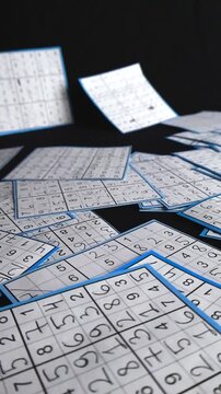 Many completed sudoku paper sheets with handwritten numbers and blue borders floating and moving across a clean black studio background. Math and logic game concept with shallow depth of field