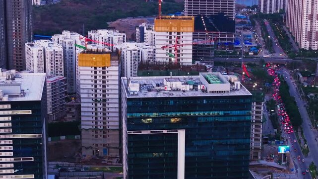 285 FD by Phoenix building with under-construction skyscrapers and heavy traffic on road at Financial District, Nanakramguda, hyderabad, Telangana, india. day time, static shot, drone shot, 4k.