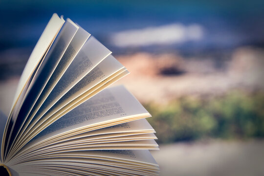 Opened book on the beach