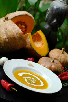 The restaurant serves creamy pumpkin soup in a white bowl