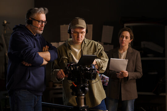 Professional film crew operating camera on studio set