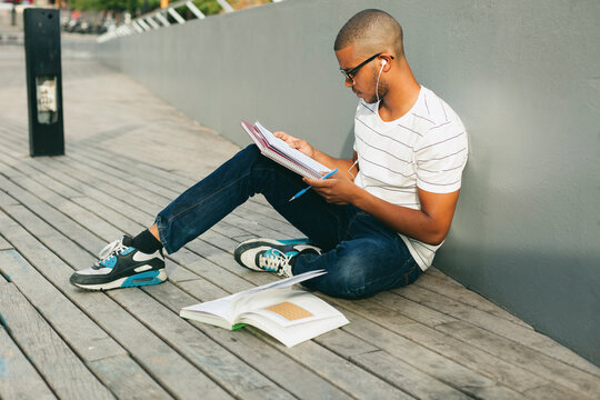 Young Afro-american man studying language