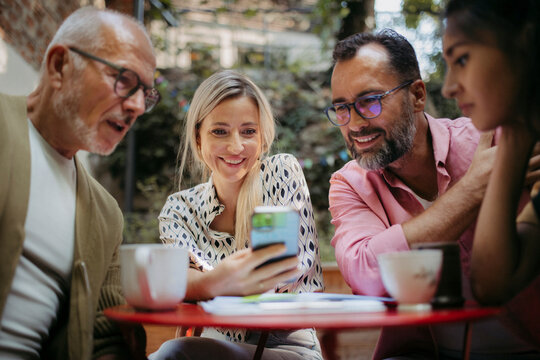 Members of the community have a meeting outdoors, sitting and planning community project.