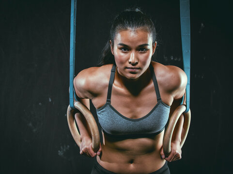 Portrait of CrossFit athlete with gymnastic rings