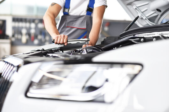 Mechanic repairing car in a garage