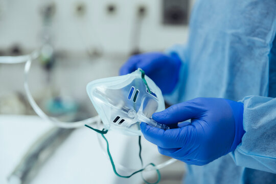 Close-up of emergeny doctor holding an oxygen mask in hospital