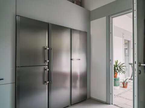 Modern stainless steel refrigerator in luxury villa kitchen