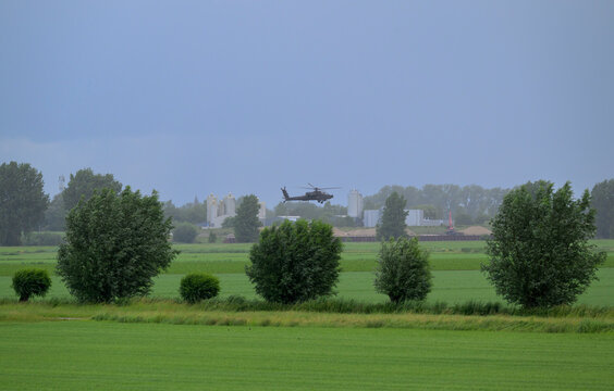 Boeing AH-64D attack helicopter flies low over Overdiepse Polder