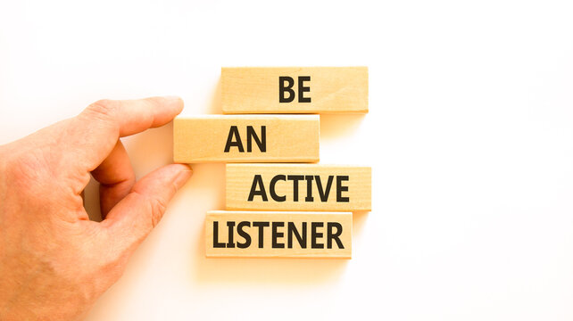 Be an active listener words symbol. Concept words Be an active listener on beautiful wooden blocks. Beautiful white background. Businessman hand. Business be an active listener concept. Copy space.