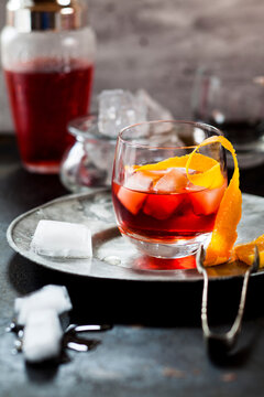 Negroni with orange peel and ice cubes