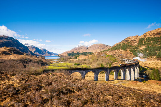 UK, Scotland, Jacobite steam train crossing Glenfinnan Viaduct
