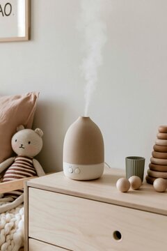 Ceramic humidifier releasing mist on pale birch dresser in a children's room with soft lighting and decorative elements visible