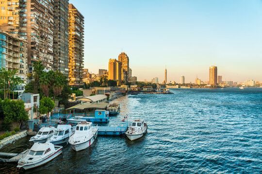 Egypt, Giza Governorate, Giza, Motorboats moored in front of apartments in Dokki