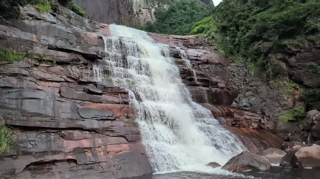 This waterfalls descend from the sandstone plateau, where mist drifts across tropical forest and rugged cliffs in a protected wilderness. Angel Falls, Canaima National Park, Venezuela.