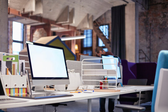 Desk in modern office with PCs