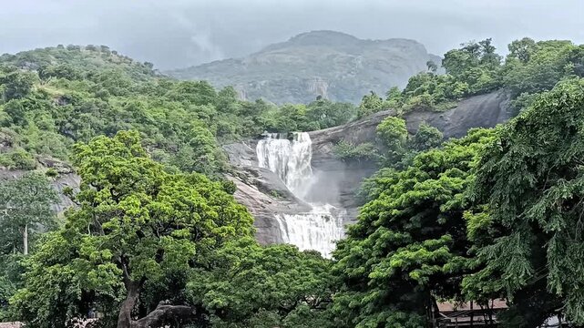 This waterfalls flow through the Western Ghats, where mineral rich streams descend over rocky ledges into lush tropical surroundings. Courtallam Falls, Tenkasi, Tamil Nadu, India.