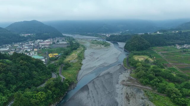 Aerial drone footage over Oi River and residential area in Shimada, Shizuoka, Japan