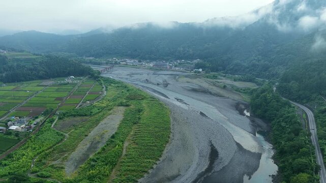 Aerial drone footage over Oi River valley and farmland in Shimada, Shizuoka, Japan
