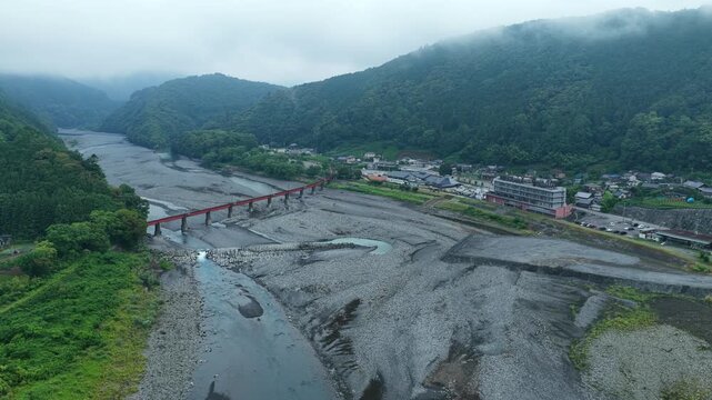 Aerial drone footage over Oi River and mountains at sunrise in Shimada, Shizuoka, Japan