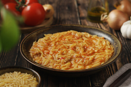 A bowl with traditional Greek soup Manestra with orzo pasta