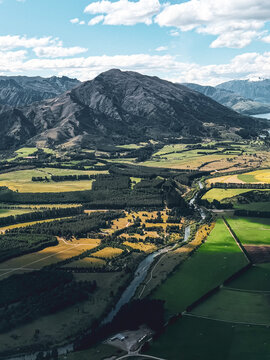 Aerial view of farmland and forest valley near Wanaka, New Zealand