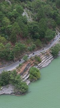 Vertical Aerial View of Bikers Riding Along Chamera Lake Road, Himachal Pradesh