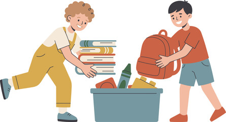 Two young children packing school supplies and books into a storage bin together.