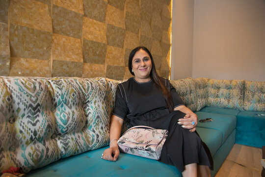Portrait of a woman sitting comfortably on the couch. 