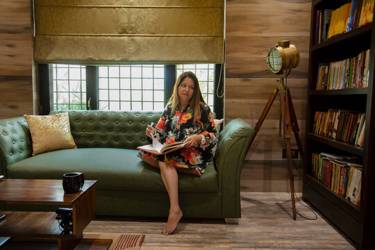 Woman spending quality time in her library.