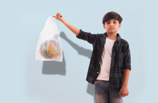 Young boy sending a message about the environment while holding a globe inside a plastic bag. (Children)