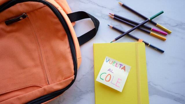 Orange backpack with school supplies for back to school