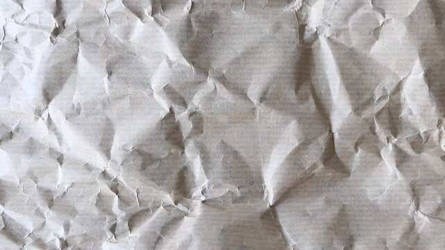 Static macro video of crumpled brown kraft wrapping paper with subtle horizontal stripes and visible paper fibers. Authentic grunge texture for vintage, packaging and distressed design backgrounds.