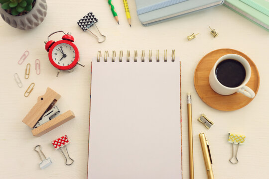 Top view image of table with coffee and office supplies