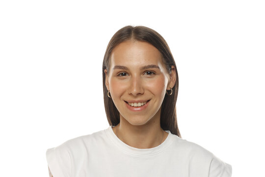 Portrait of a happy young woman laughing with a big smile, natural beauty, no makeup, on white background.