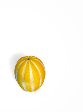 Fresh Korean Melon Chamoe on White Background with Copy Space.A single fresh Korean melon, also known as Chamoe or Oriental melon, with vibrant yellow and white stripes isolated on a clean white backg