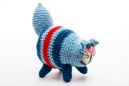A crocheted cat toy on a white background