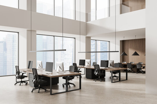 Contemporary open plan office interior with double height windows, workstations, pendant lighting and warm wood accents in a bright workspace. 3D Rendering