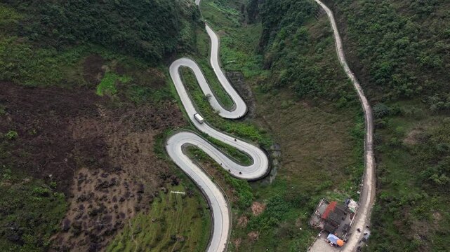 Aerial View Of the Winding Tham Ma Mountain Pass In Ha Giang Province In Vietnam - Ha Giang Loop Drone Shot at Sunset.