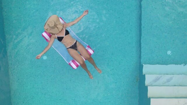 Woman Relaxing on Inflatable in Luxury Villa Pool Chalkidiki Greece