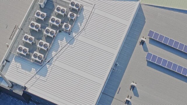 Aerial view of air conditioners and solar panels on a rooftop