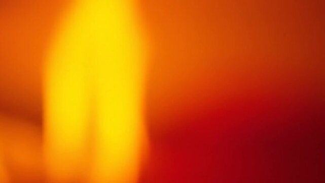 Abstract warm-colored motion blurred visuals with vibrant orange and yellow hues in dynamic shifting patterns