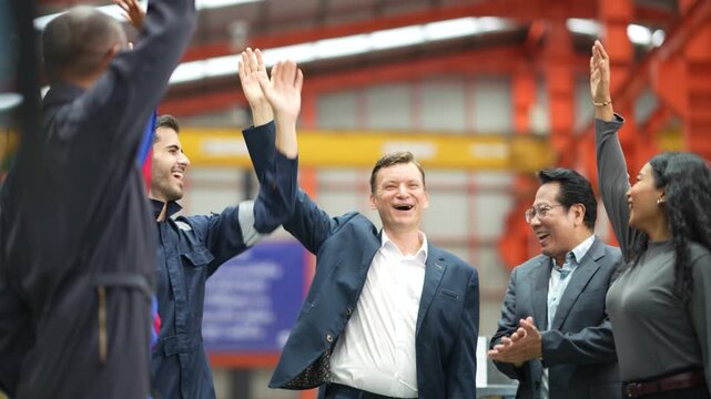 Engineering team joining hands during factory meeting, manufacturing collaboration, industrial workforce, production teamwork, workplace motivation, leadership and team spirit.