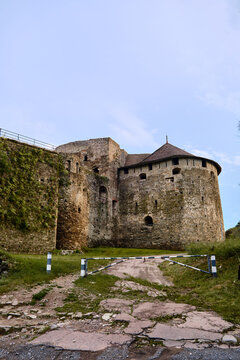 Kamianets-Podilskyi, Ukraine, june 23, 2026 A low-angle shot of the massive stone walls and round defensive towers of a medieval fortress or castle under a clear sky.