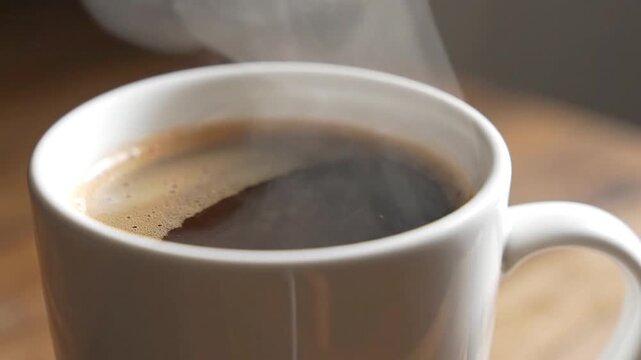 Steaming Hot Black Coffee in White Ceramic Mug