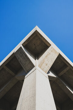 Modern concrete building corner against clear blue sky