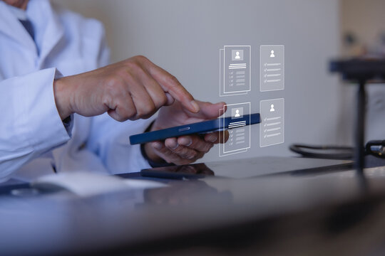 Doctor reviewing electronic medical records on tablet with digital patient profiles in a modern clinic. Healthcare technology