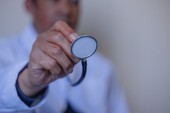 doctor holding stethoscope in a modern clinic, symbolizing healthcare, medical diagnosis