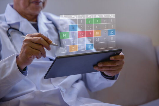 Doctor managing digital appointment calendar on tablet in a modern clinic. Healthcare scheduling patient management, medical planning electronic records telemedicine and workflow efficiency.