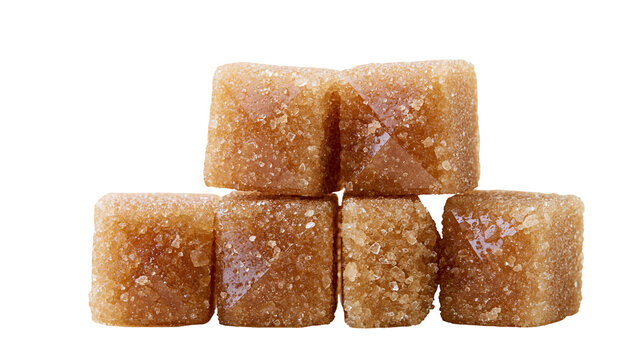 Brown sugar cubes stacked on white