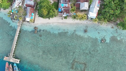 Top down view of a tropical shoreline and wooden pier © Iswanto